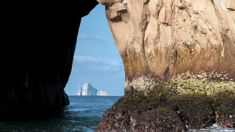 View of Kicker Rock through a cave in the Galápagos