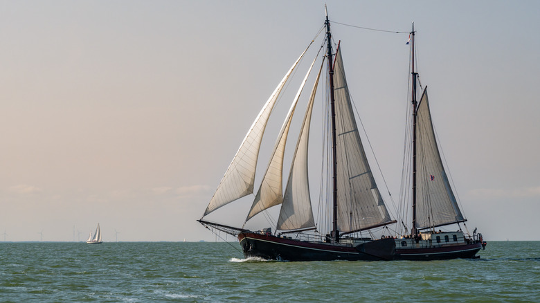 a traditional ship with five sails on the IJsselmeer