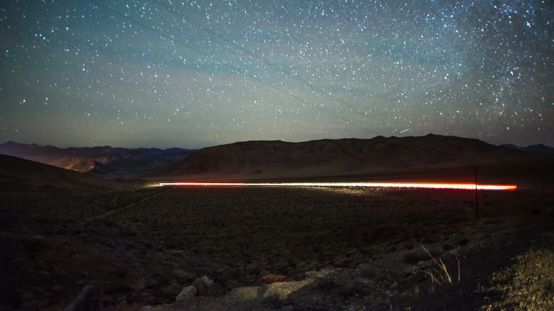 Lights from the Star Train in Ely, Nevada, with a starry sky above