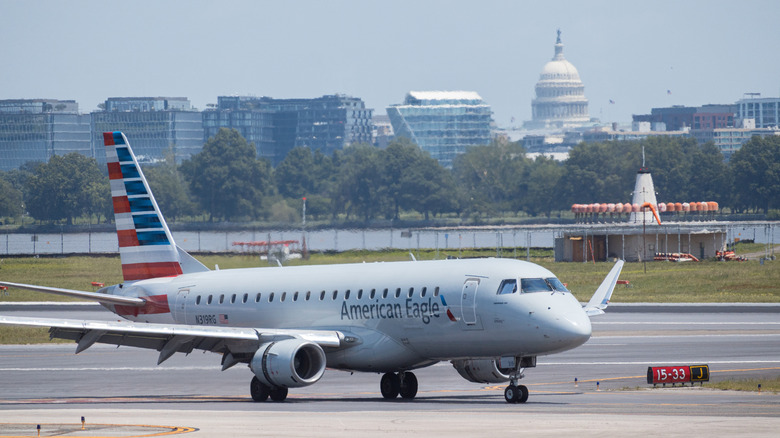 Airplane on the tarmac with the White House in the background
