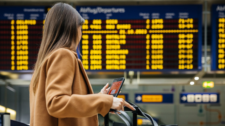 Person with a boarding pass on their phone at the airport