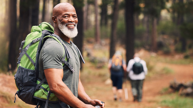 A happy backpacker in the woods