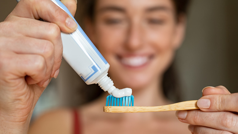 Putting toothpaste on a toothbrush