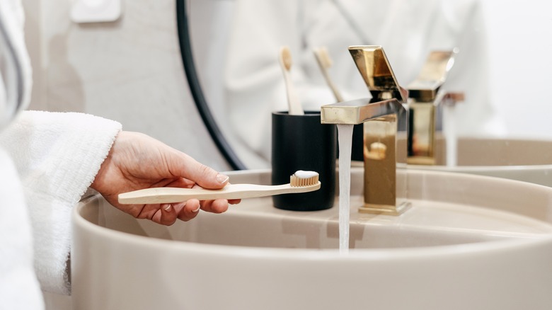 Toothbrush near a running faucet