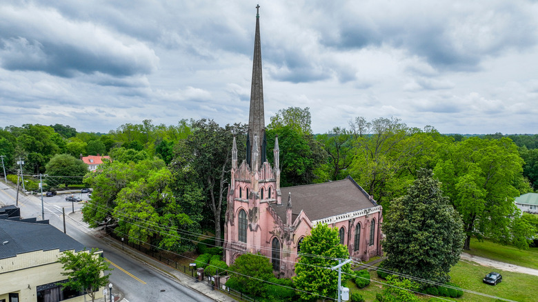 Gothic-style Trinity Episcopal Church against trees and lawns in downtown Abbeville, South Carolina