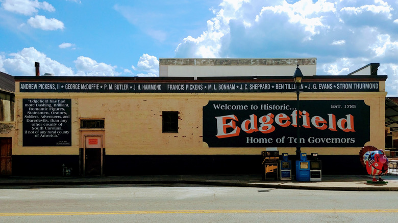 Painted sign of Edgefield Home of Ten Governors against a yellow building facade in Edgefield, South Carolina