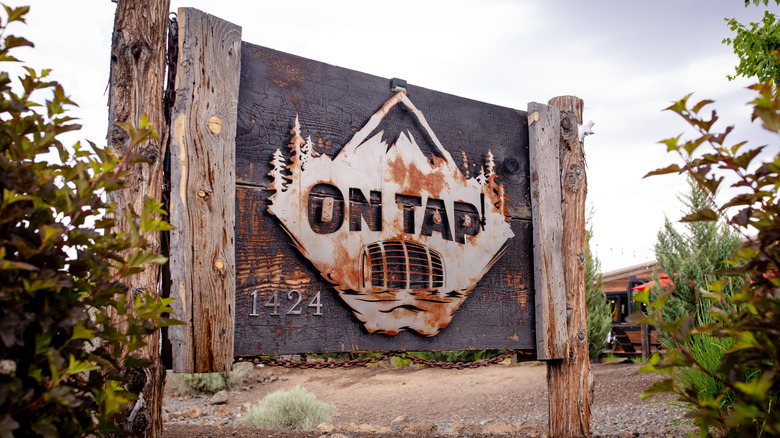 Rustic wooden sign that reads 