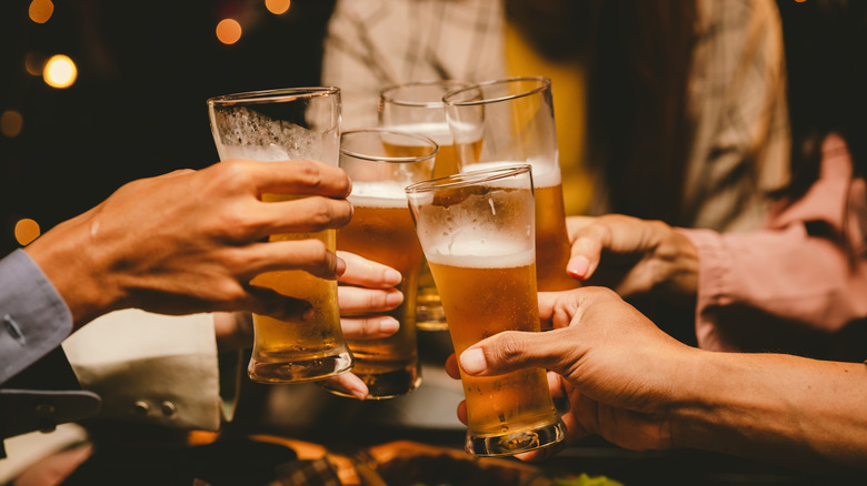 Group of friends toasting with beer