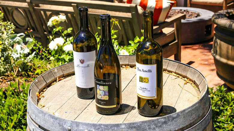 Local wine bottles on a barrel outside a restaurant in Los Olivos, California
