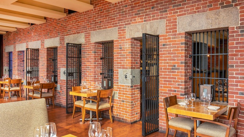 The restaurant Clink at the Liberty Hotel Boston featuring original iron cell doors and brick walls