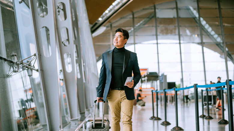 Man carrying a bag in an airport