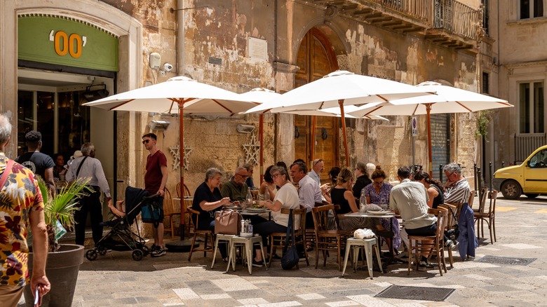 People dining outside an Italian restaurant