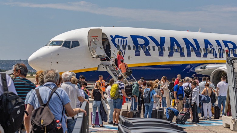 Travelers boarding a Ryanair flight