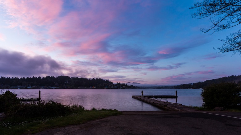 Beautiful view of the Devil's Lake at sunset from the bank in the East Devil's Lake State Recreation Area in Lincoln City, Oregon, USA