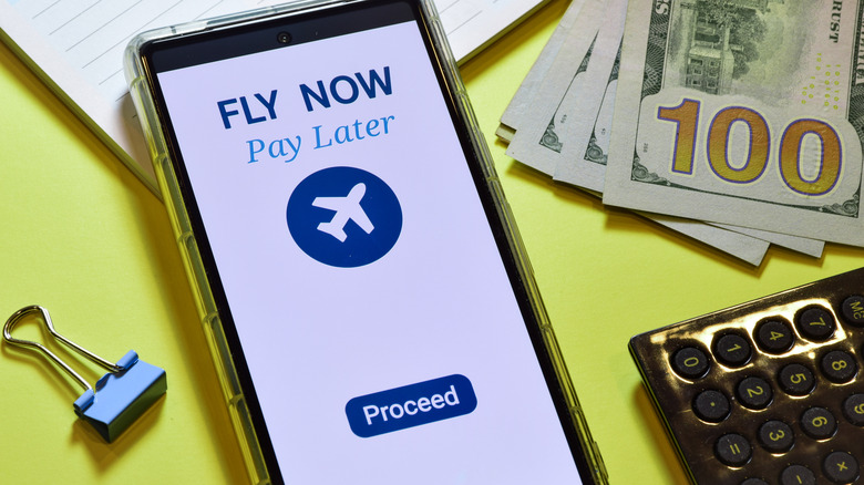 Smartphone cash and calculator on table