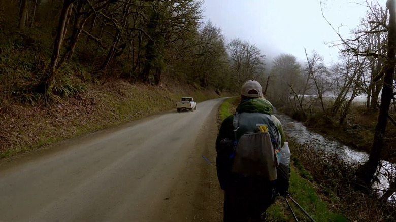 A hiker on a road, part of the C2C trail
