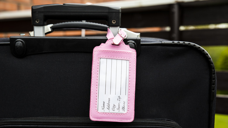 Suitcase with blank luggage tag on it