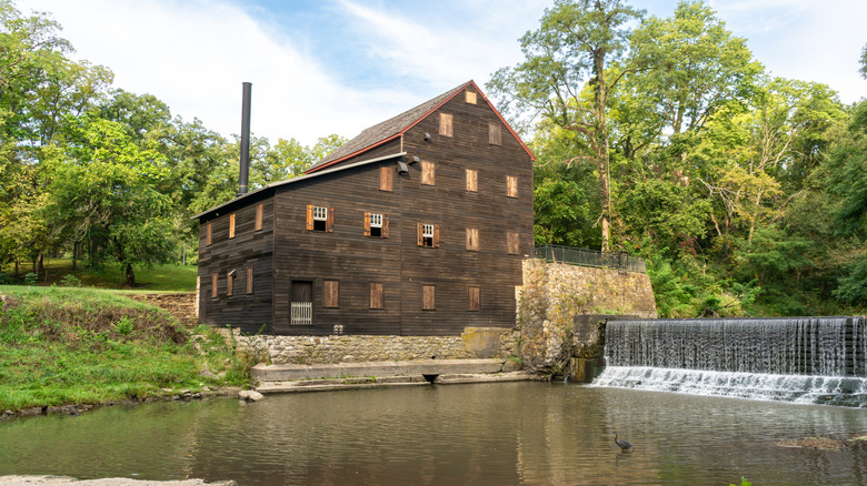 Brick mill with a water stream and gardens