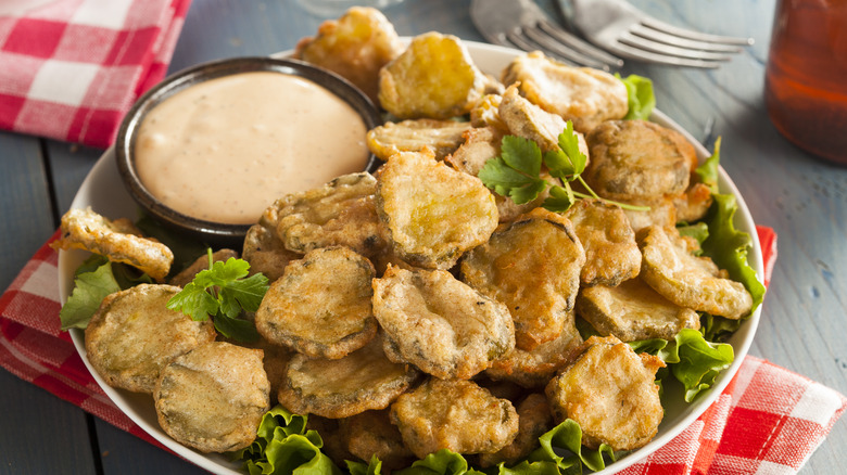 A bowl of battered and fried pickles