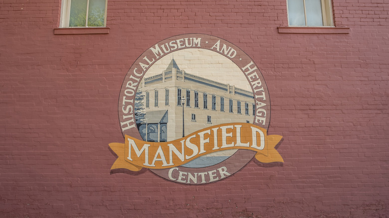 The painted sign for the Mansfield Historical Museum and Heritage Center on a brick wall