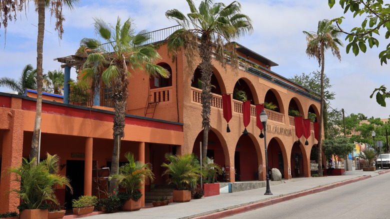 Exterior of Hotel California with palm trees in Todos Santos, Mexico