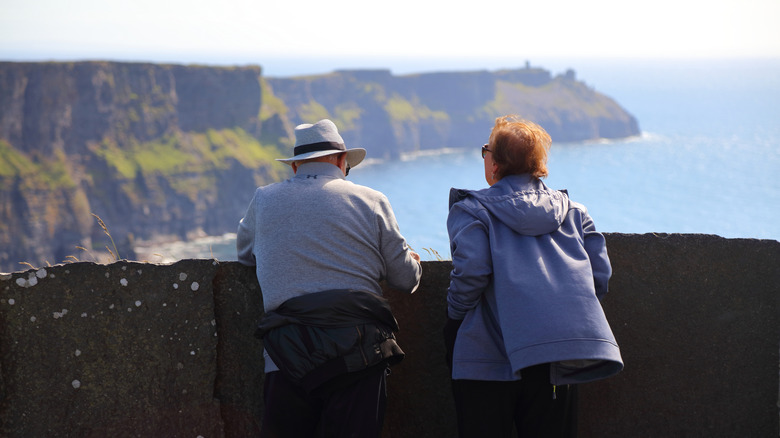 Senior pair looking out over the Cliffs of Moher in Ireland
