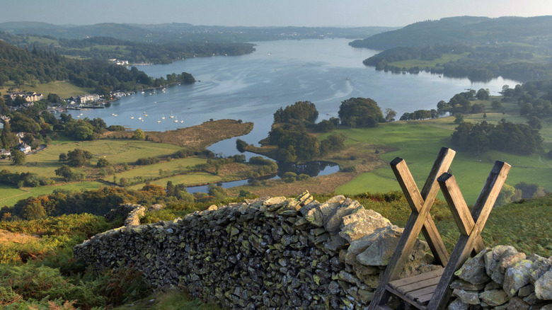 A stone wall with water in the distance in the Lake District