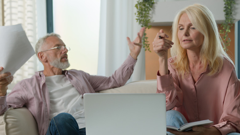 A frustrated couple in front of a laptop