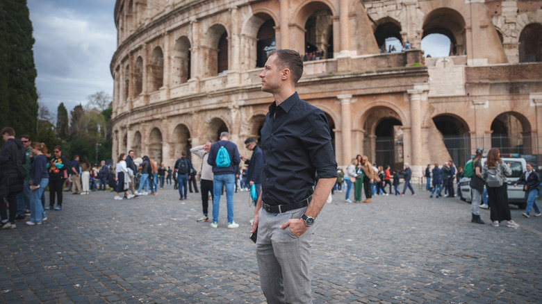 A lone traveler in front of the Colosseum