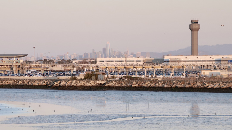 The Oakland airport tower seen with San Francisco skyline in the background