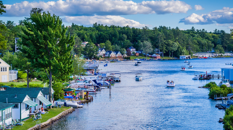 Boats and homes on the shores of Lake Winnipesauke during a sunny day.