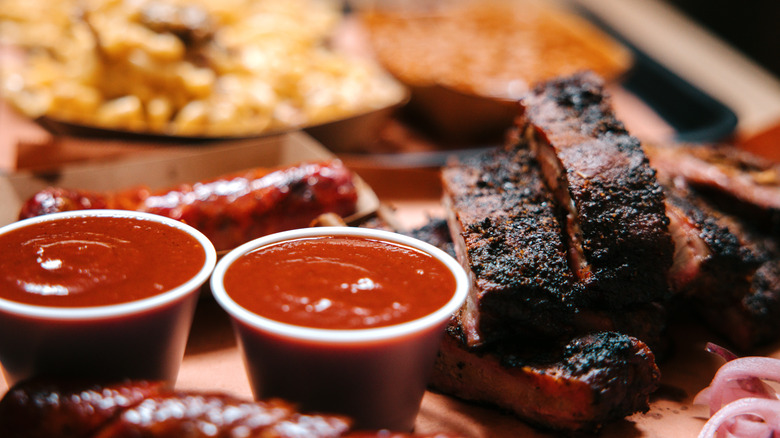Large serving of barbecue, with pork ribs, sausage, macaroni and cheese, and baked beans