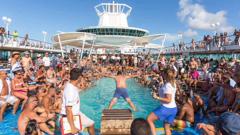 People hanging by the pool on a cruise ship
