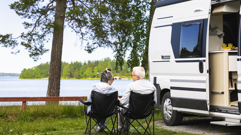 Couple talks outside an RV