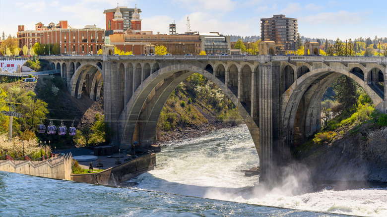 Stone arch bridge crosses Spokane River near Riverfront Park in Spokane, Washington
