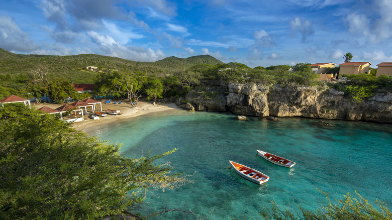 A turquoise water with two boats