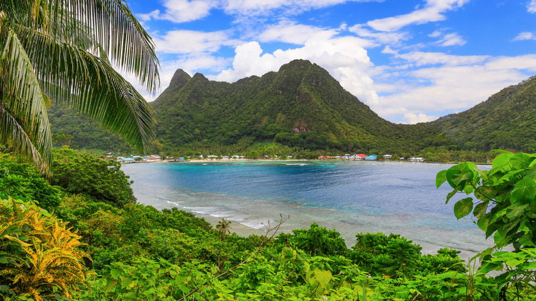 A beautiful tropical setting with mountains and clear blue water