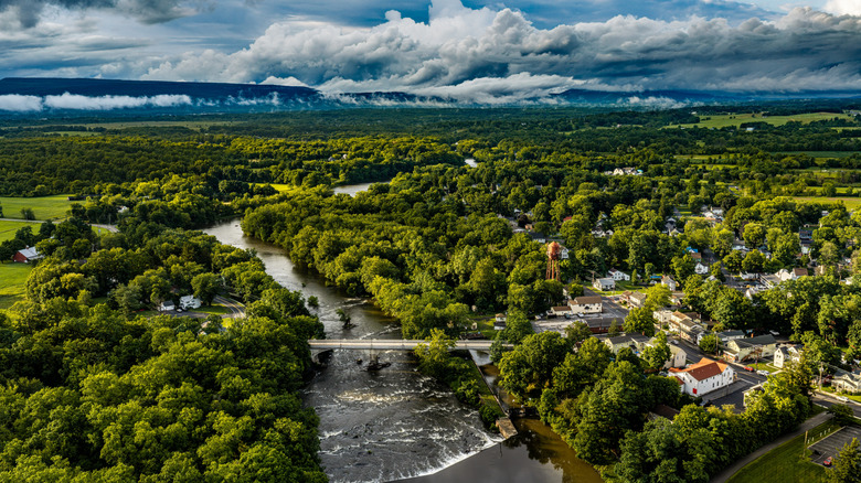 An aerial view of the town of Shawangunk, with a river and lush trees