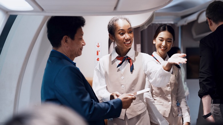 cabin crew directing passengers