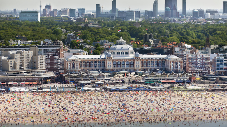 People enjoying the beach during the warm season in front of the Grand Hotel
