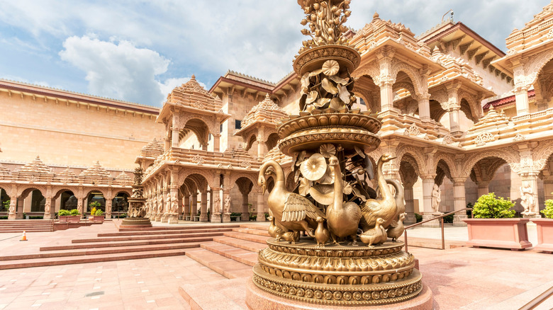 Statue of Nilkanth Varni with temple in the back at Swaminarayan Akshardham in Robbinsville, New Jersey