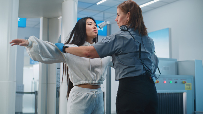 A woman getting a pat down at TSA
