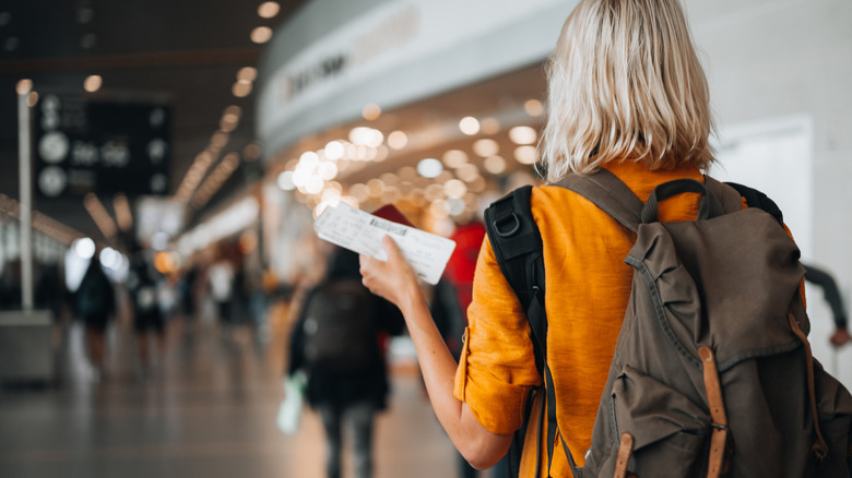 A woman holding her boarding pass