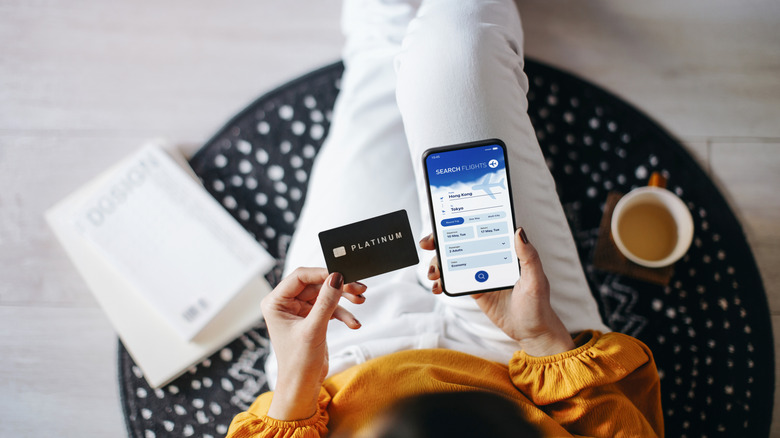 A woman booking a flight on her smartphone