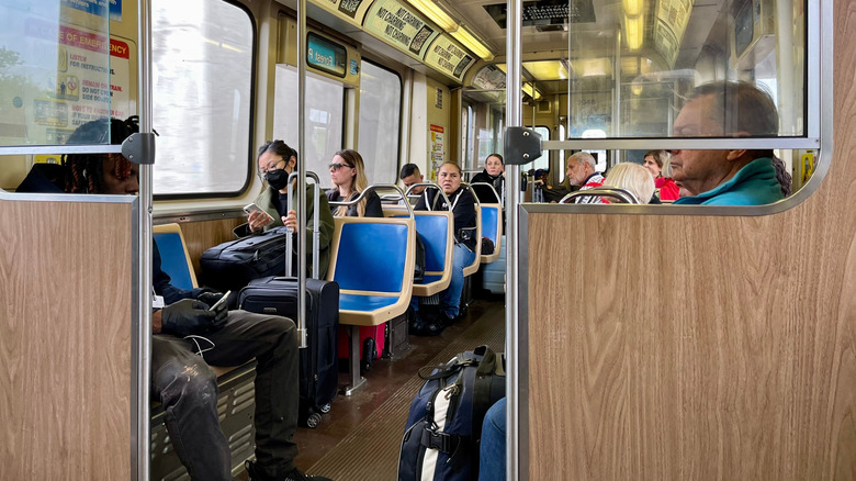 Commuters ride the L Train from O'Hare Airport to downtown Chicago