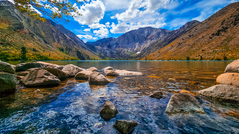View of Convict Lake in Mono County, California in autumn with golden foliage and dramtic peaks surrounding the lake