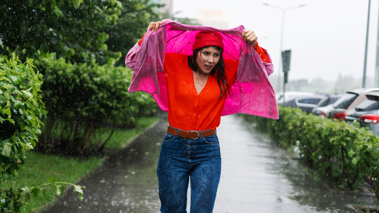 Woman getting drenched by rain
