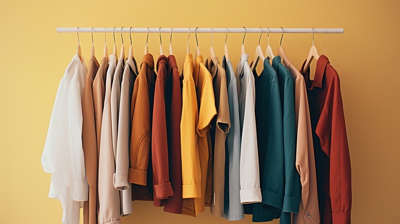 Autumn-colored shirts hanging on a coat rack