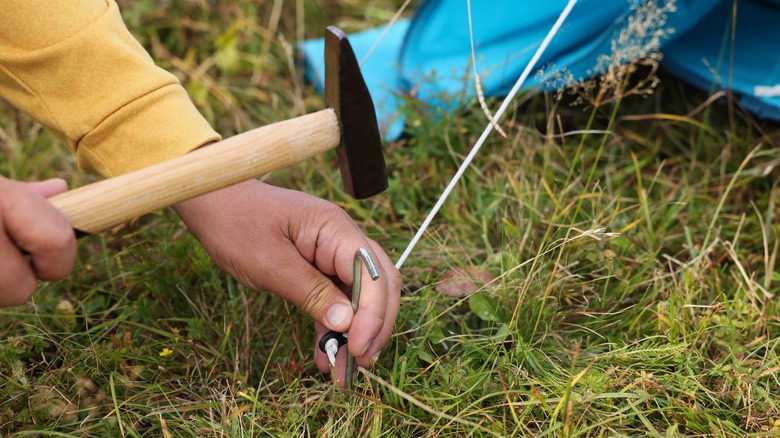 hammering in stake for tent