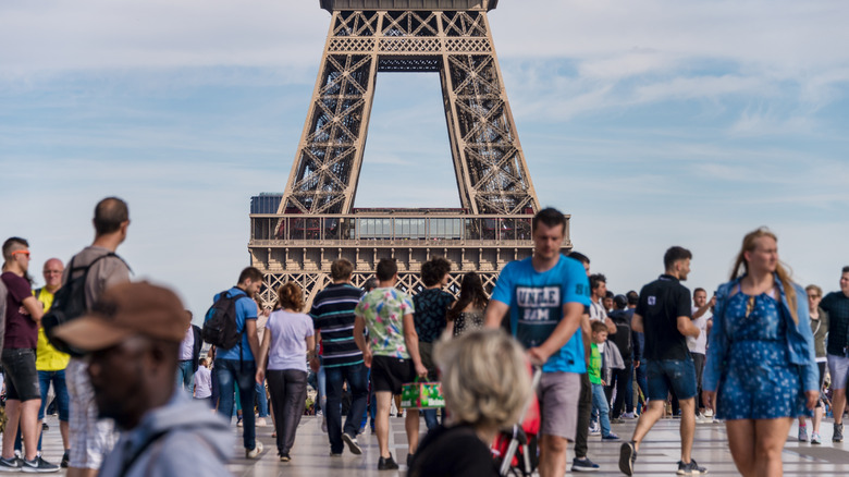 A crowd of tourists in front of the Eiffel Tower in Paris, France